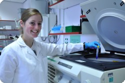 woman taking a sample out of a machine